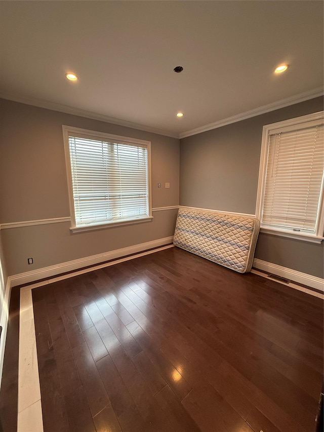 empty room with baseboards, recessed lighting, and crown molding