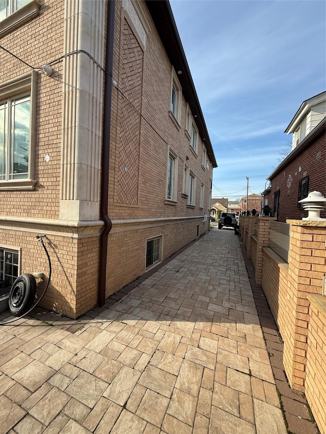 view of home's exterior with a patio area and brick siding