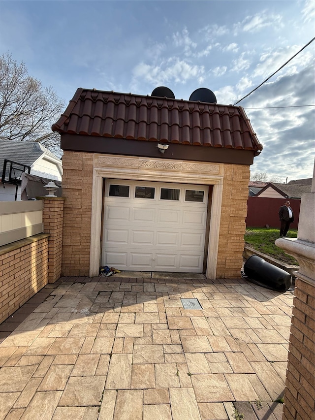 garage with decorative driveway