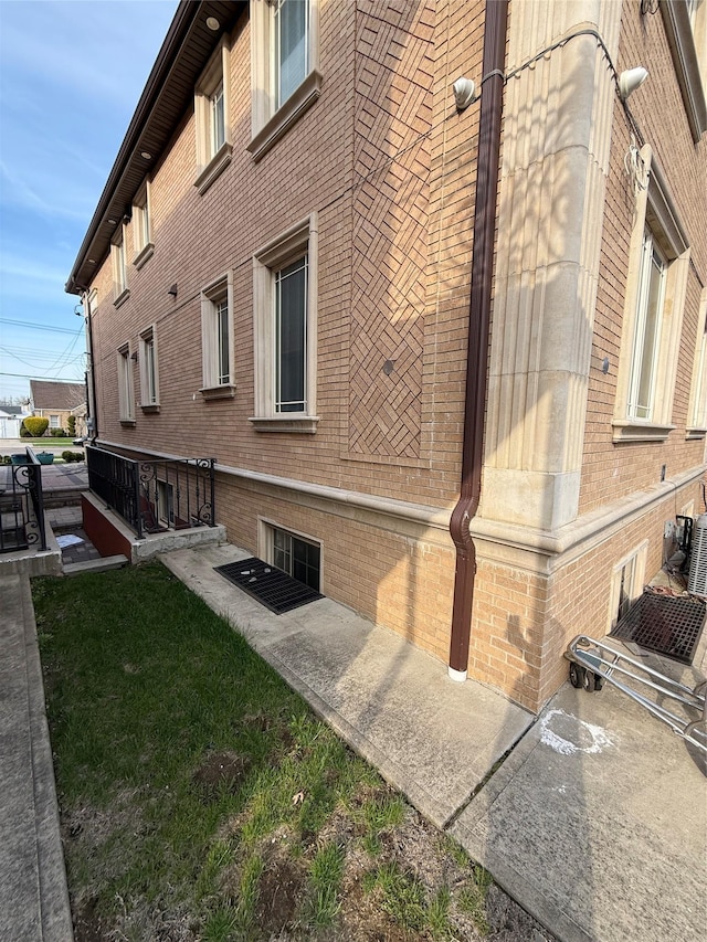 view of property exterior with brick siding