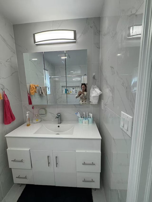 25-19 120th St, College Point, NY 11356 - bathroom with tile walls, a walk in shower, vanity, and tasteful backsplash