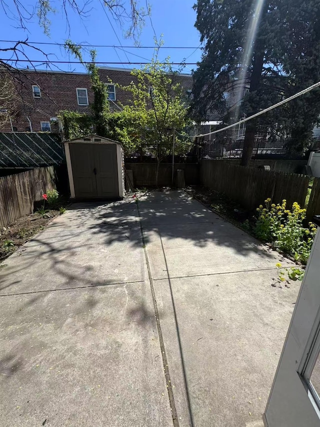 25-19 120th St, College Point, NY 11356 - fenced backyard with a storage unit and a patio