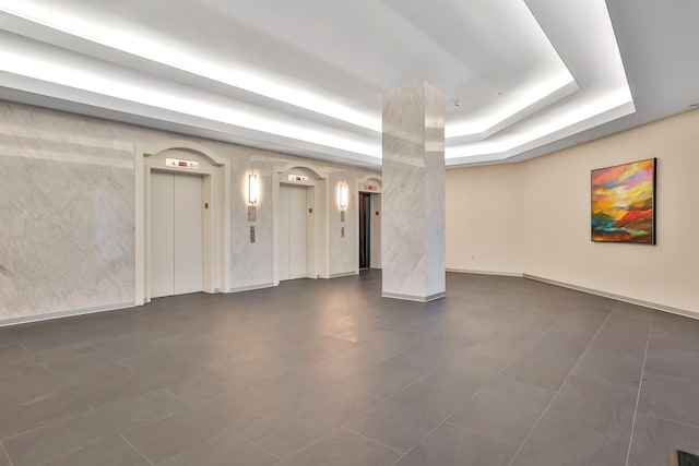 interior space featuring baseboards and elevator