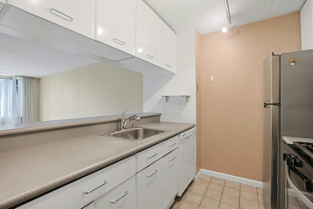kitchen featuring light tile patterned floors, a sink, white cabinetry, dishwasher, and gas stove