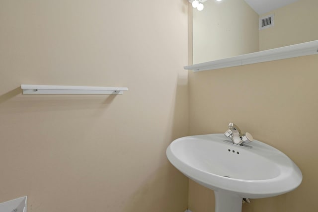 bathroom with visible vents and a sink