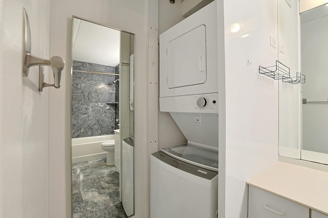 laundry room with stacked washing maching and dryer and laundry area