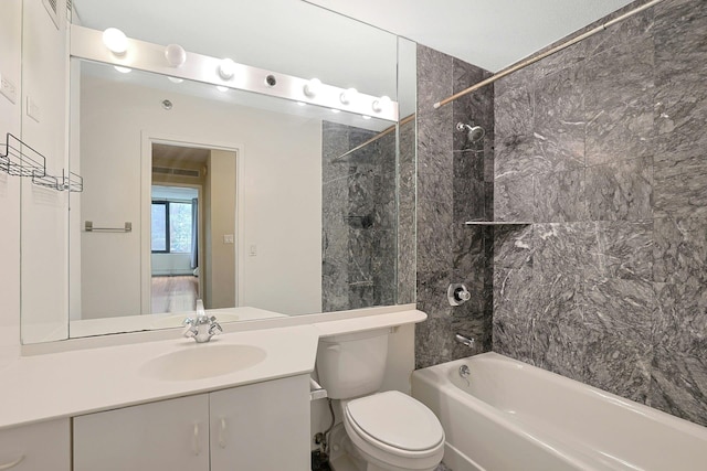 bathroom featuring toilet, shower / bathtub combination, and vanity