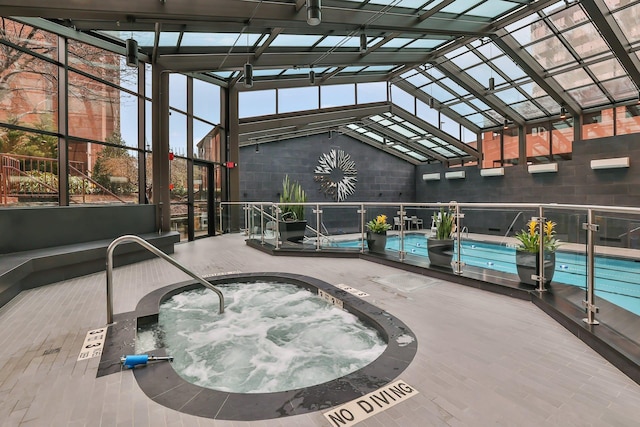 pool with an indoor in ground hot tub