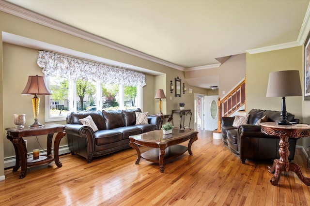 living room with stairs, a baseboard heating unit, ornamental molding, and light wood-style floors
