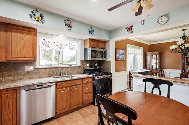 kitchen featuring a sink, appliances with stainless steel finishes, and brown cabinets