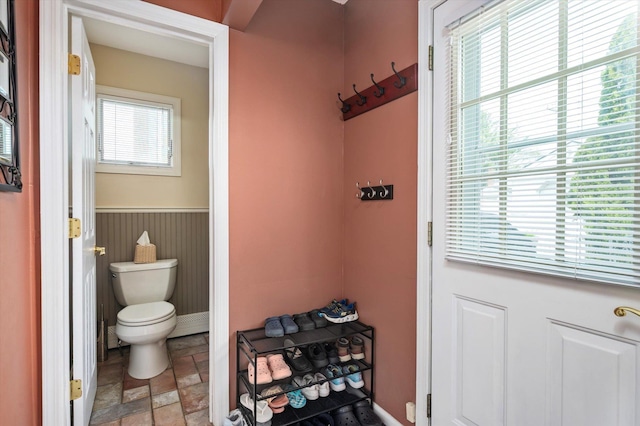 bathroom featuring toilet and stone finish floor