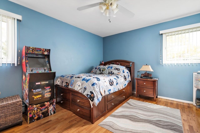 bedroom featuring baseboards, a ceiling fan, and wood finished floors