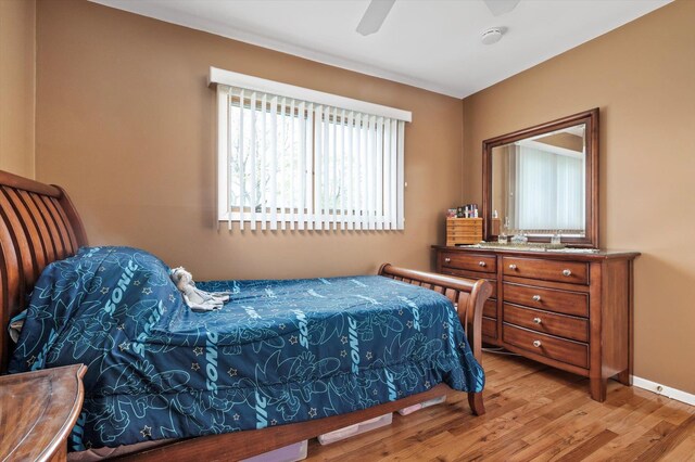 bedroom with baseboards, a ceiling fan, and wood finished floors