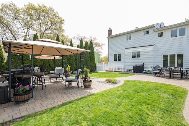 view of yard with outdoor dining area, a patio area, and fence