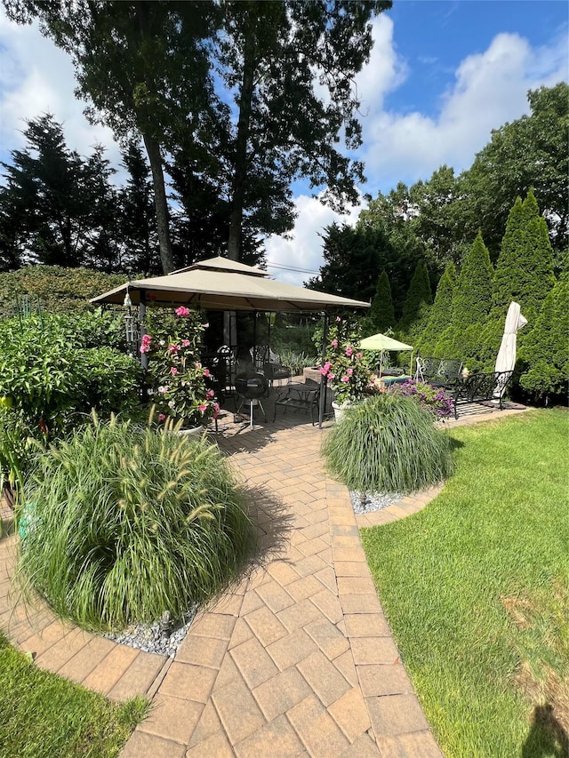 surrounding community featuring a yard, a patio, and a gazebo