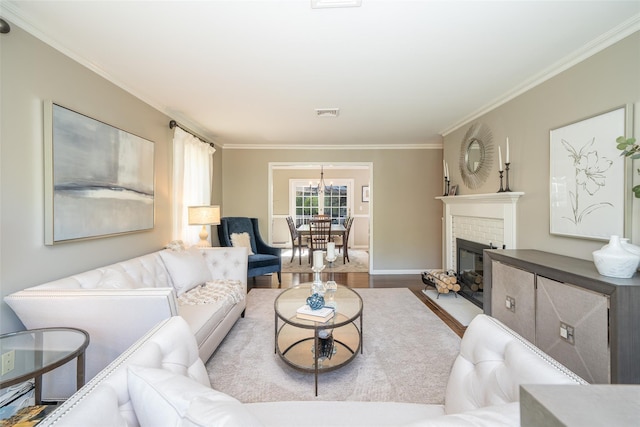 living room with crown molding, baseboards, wood finished floors, and a fireplace
