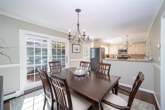 dining room with crown molding, a baseboard heating unit, wood finished floors, and a chandelier
