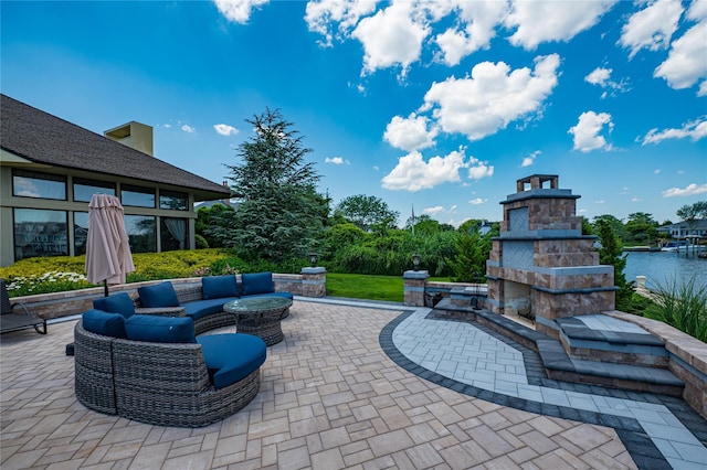 136 The Helm, East Islip, NY 11730 - view of patio with an outdoor living space with a fireplace and a water view