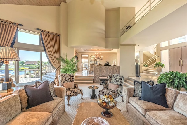 136 The Helm, East Islip, NY 11730 - living area featuring a towering ceiling, a chandelier, plenty of natural light, stairway, and carpet flooring