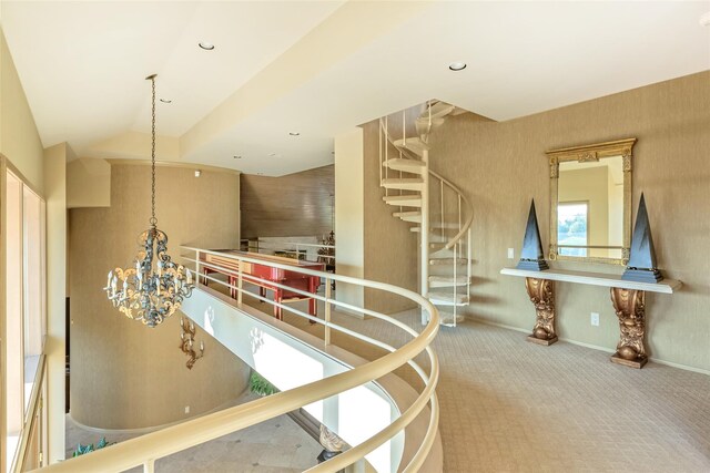 136 The Helm, East Islip, NY 11730 - stairway featuring carpet floors, a chandelier, and vaulted ceiling