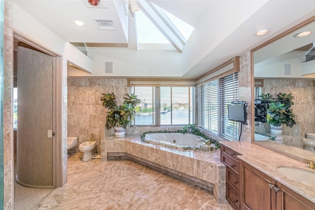 136 The Helm, East Islip, NY 11730 - full bath featuring a bidet, a tub with jets, vanity, and tile walls