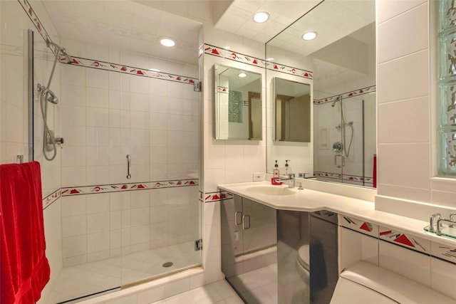 136 The Helm, East Islip, NY 11730 - full bath with a stall shower, vanity, recessed lighting, and tile walls