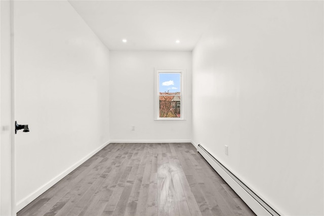 179-55 Anderson Rd, Jamaica, NY 11434 - empty room with baseboard heating, recessed lighting, wood finished floors, and baseboards