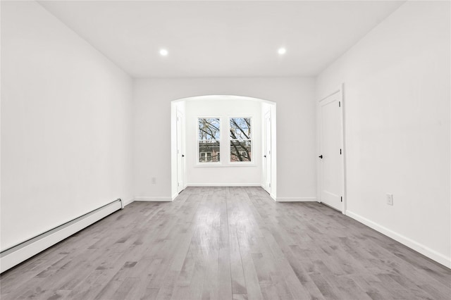 179-55 Anderson Rd, Jamaica, NY 11434 - empty room with a baseboard heating unit, recessed lighting, arched walkways, and wood finished floors