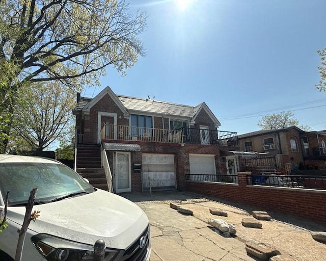 view of front facade featuring stairs, fence private yard, an attached garage, and brick siding
