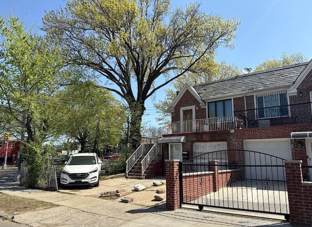 view of front of property with driveway, a garage, stairway, and brick siding