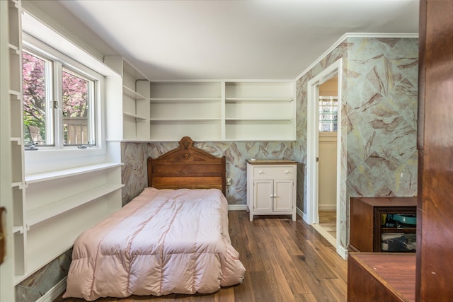 bedroom featuring a fireplace and wood finished floors