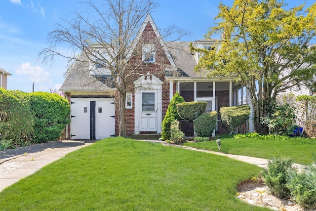 444 W Olive St, Long Beach, NY 11561 - view of front facade featuring brick siding, roof with shingles, and a front yard