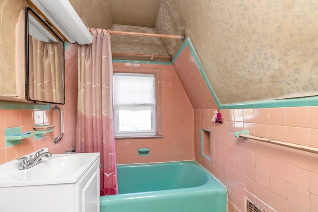 444 W Olive St, Long Beach, NY 11561 - full bath featuring tile walls, vaulted ceiling, and vanity