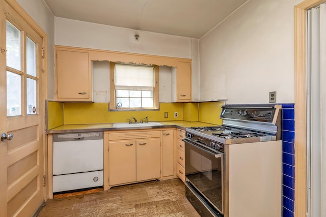 444 W Olive St, Long Beach, NY 11561 - kitchen with light countertops, cream cabinetry, range with gas cooktop, a sink, and dishwasher