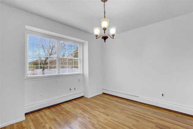176 Jackson Ave, Syosset, NY 11791 - unfurnished room with a baseboard heating unit, a chandelier, light wood finished floors, and baseboards