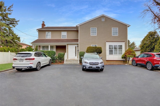 176 Jackson Ave, Syosset, NY 11791 - traditional-style house with a chimney and a shingled roof