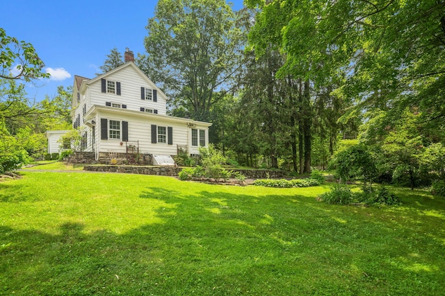 27 Bedford Rd, Pleasantville, NY 10570 - rear view of property featuring a chimney and a yard