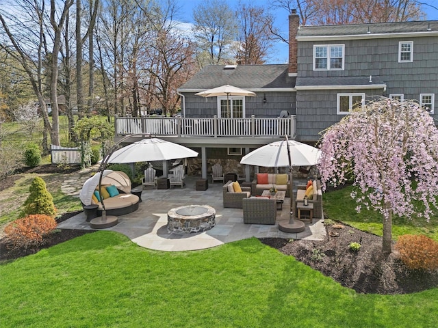 8 Richard Somers Rd, Granite Springs, NY 10527 - rear view of property featuring a patio, a chimney, an outdoor living space with a fire pit, a yard, and roof with shingles