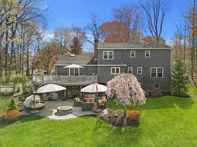8 Richard Somers Rd, Granite Springs, NY 10527 - rear view of house featuring a patio, a chimney, a deck, a lawn, and an outdoor living space with a fire pit