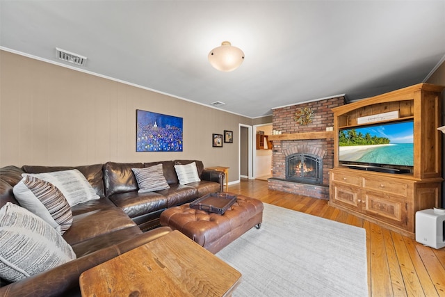 8 Richard Somers Rd, Granite Springs, NY 10527 - living room with crown molding, visible vents, a brick fireplace, and hardwood / wood-style flooring