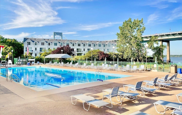 pool featuring a patio and fence