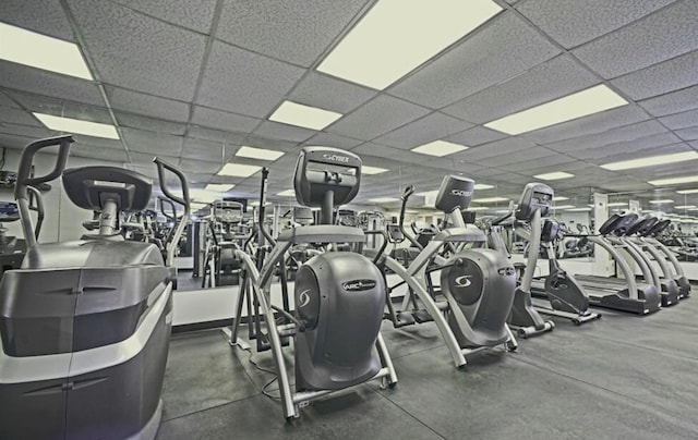 gym with a paneled ceiling