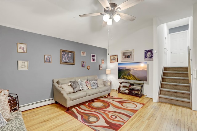 living area featuring stairway, ceiling fan, hardwood / wood-style flooring, and a baseboard radiator