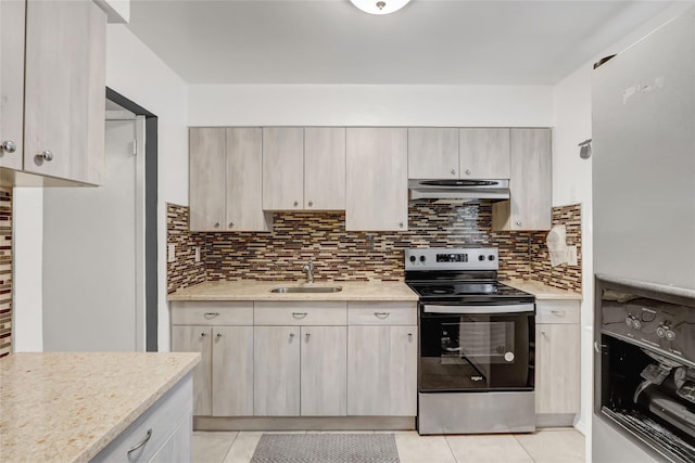 kitchen featuring decorative backsplash, a sink, under cabinet range hood, electric stove, and light tile patterned floors