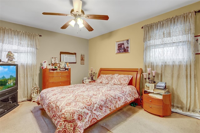 bedroom featuring an AC wall unit, a ceiling fan, and carpet
