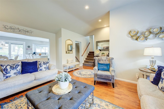 living room with light wood-style floors, stairs, recessed lighting, baseboards, and lofted ceiling