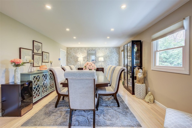 dining room featuring baseboards, light wood finished floors, and recessed lighting