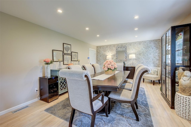 dining area featuring visible vents, baseboards, wallpapered walls, recessed lighting, and light wood-type flooring