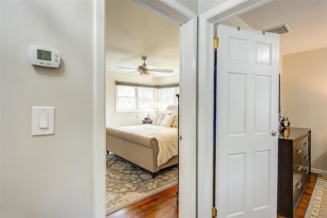 bedroom with visible vents, ceiling fan, and wood finished floors