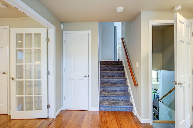 stairway with baseboards and wood finished floors